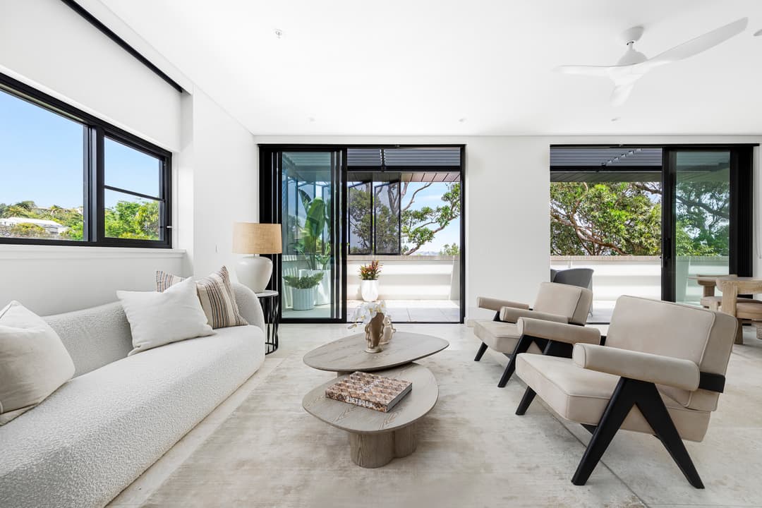 Modern living room with neutral tones and outdoor views